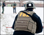 An FBI agent participates in exercise in snow during pre-deployment training