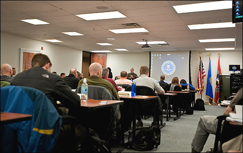 FBI personnel receive training in a classroom.
