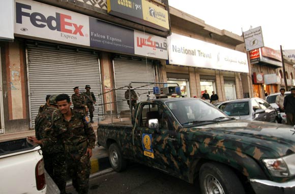 Yemeni security outside of a FedEx branch.